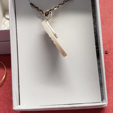 Load image into Gallery viewer, This fun little 1.25&quot; Fossil Mammoth Ivory Necklace has been hand carved from 10,000 year old Mammoth Ivory found in Alaska. The color added is permanent India Ink. Set with a 18&quot; gun metal silver chain. 
