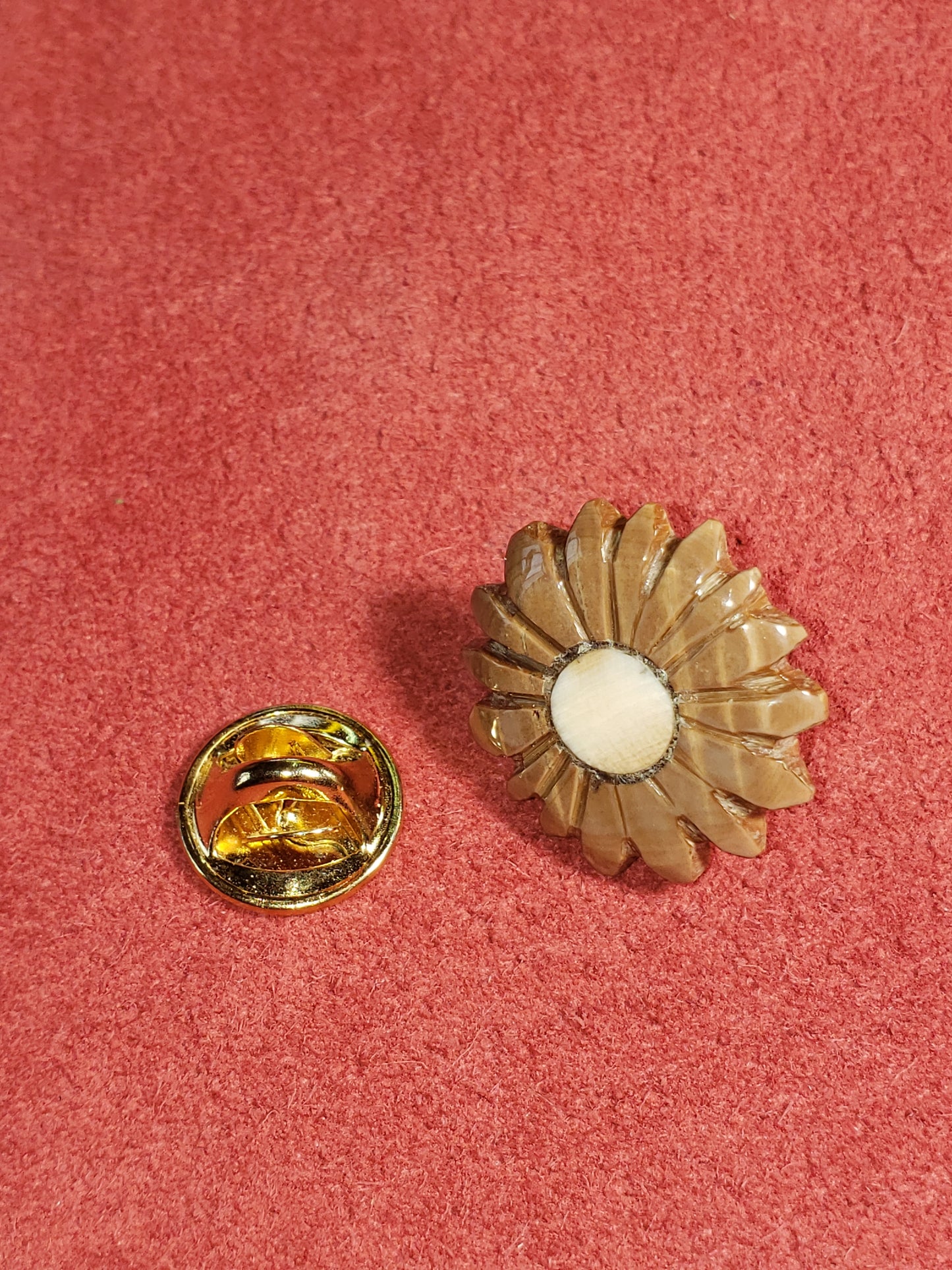 This Gentlemen's Tie Tack is made completely from Mammoth Ivory. The center piece is about 10,000 years old and the petals are 30,000 year old Fossil Mammoth Ivory, both found in Alaska. This piece is mounted with shiny Brass findings. .75"