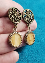 Load image into Gallery viewer, This pair of Rare Yellow Fossil Mammoth Ivory earrings is approximately 15,000 years of age. The Mammoth Ivory that this pair is made from was found is Siberia. They are colored just the way the Ivory was found and naturally stained by the Iron ore in the

