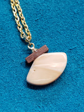 Load image into Gallery viewer, This tiny necklace is designed in the old world art of scrimshaw on Fossil Walrus Ivory found in Alaska. The artist is unknown. 3/4&quot;×1/2&quot; in size and hung on a nice 18&quot; gold chain.
