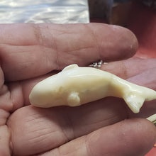 Load image into Gallery viewer, This 2&quot; long hand carved Whale Necklace has been crafted from Fossil Walrus Ivory by an unknown artist in Alaska. We think it was made around the mid 1950&#39;s. There is a hairline crack on the backside which most ivory comes with. It has been sealed.
