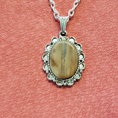 This tiny delicate necklace has been handcrafted from Alaskan Fossil Mammoth Ivory that is approximately 25,000 years old. All the unique coloring seen in this piece are colors absorbed from the minerals that the Mammoth Ivory Tusk has lain in. This neck