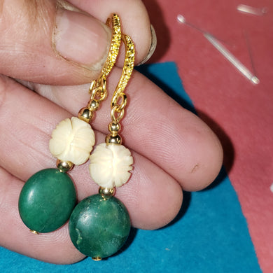 These Turquoise earrings are old. These hand carved mammoth ivory beads are estimated to have been made in the late 1700's and are highlighted with turquoise flat round beads of unknown origin.