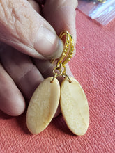 Load image into Gallery viewer, This pair of 3000 year old Alaskan Fossil Walrus Ivory Earrings are simple but yet elegant with fance gold plated ear wires. 1&quot;x.50&quot;
