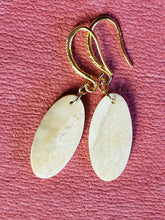 Load image into Gallery viewer, This pair of 3000 year old Alaskan Fossil Walrus Ivory Earrings are simple but yet elegant with fance gold plated ear wires. 1&quot;x.50&quot;
