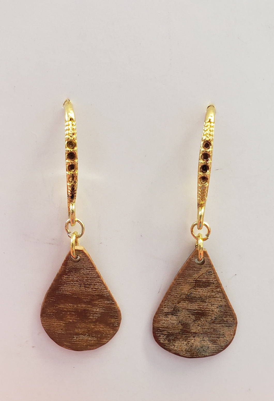 This pair of Alaskan Fossil Mammoth Ivory Earrings are about 25,000 years old and very uniquely colored. They are 1